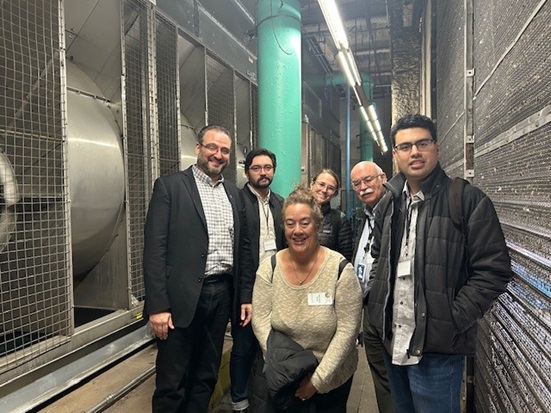 CPUC staff posing next to hotel energy plant 