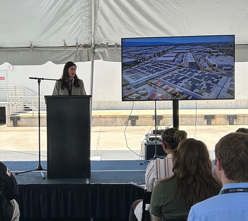 Director Fleisher delivers remarks at a podium.