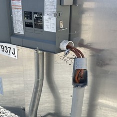 Vandalized wire housing exposing signal wires