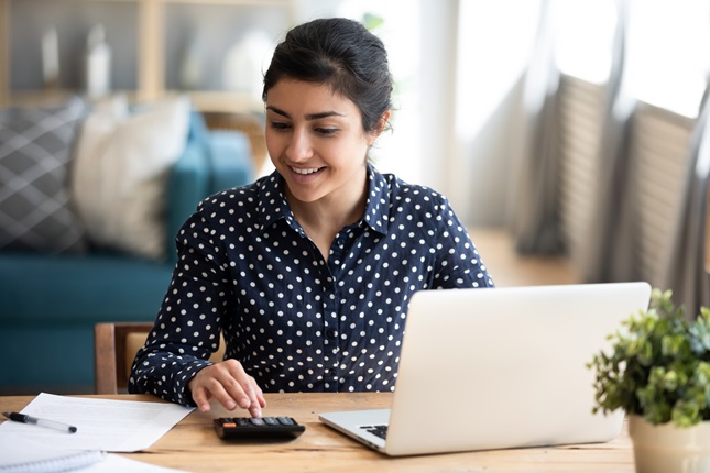 A young woman paying bills